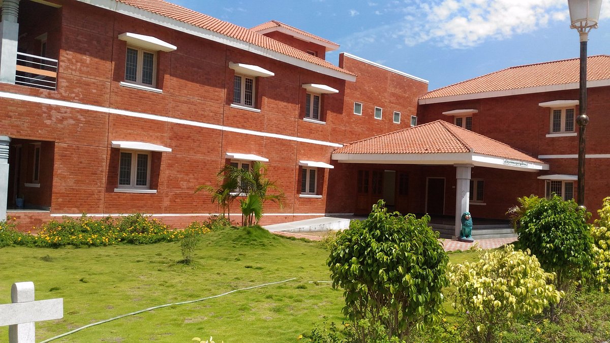 Red-brick guest house block with garden and portico